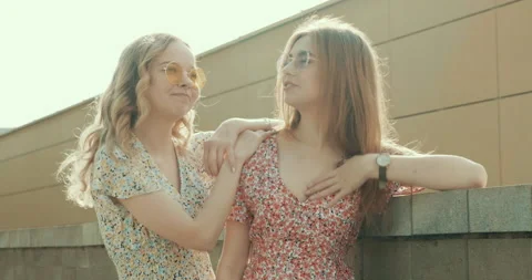 Two young beautiful smiling hipster girls in trendy summer sundress Stock Footage 142273374