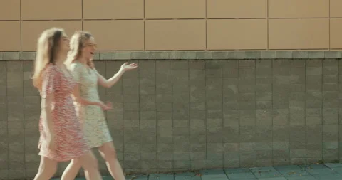 Two young beautiful smiling hipster girls in trendy summer sundress Stock Footage 142273635