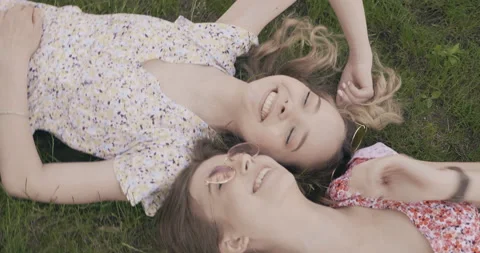 Two young beautiful smiling hipster girls in trendy summer sundress Stock Footage 142274202