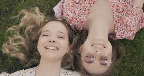 Two young beautiful smiling hipster girls in trendy summer sundress Stock Footage 142274376