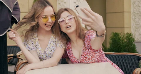 Two young beautiful smiling hipster girls Stock Footage 142275853