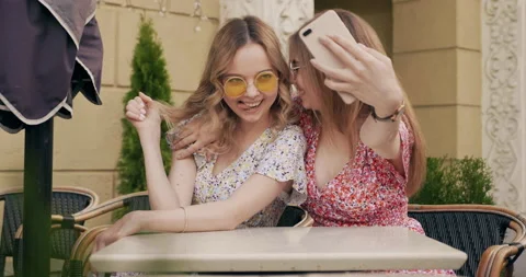 Two young beautiful smiling hipster girls Stock Footage 142275871