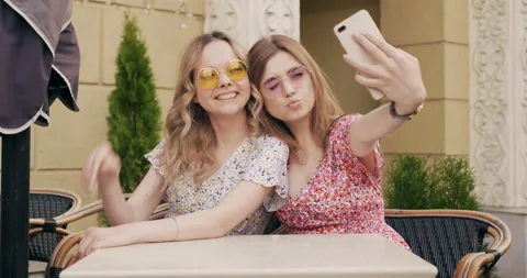Two young beautiful smiling hipster girls Stock Footage 142276345