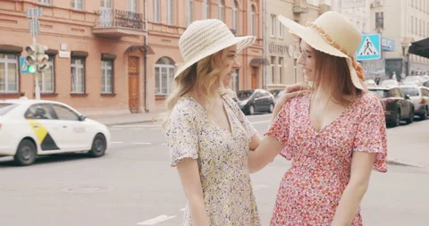 Two young beautiful smiling hipster girls in trendy summer sundress Stock Footage 142278037