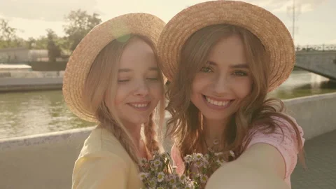 Two young beautiful smiling hipster woman in trendy summer sundress Stock Footage 142428396