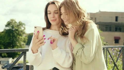 Two young beautiful smiling hipster girls Stock Footage 142556432