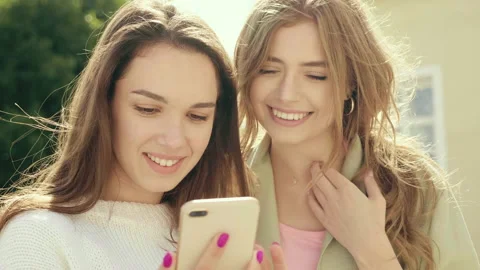 Two young beautiful smiling hipster girls Stock Footage 142556528