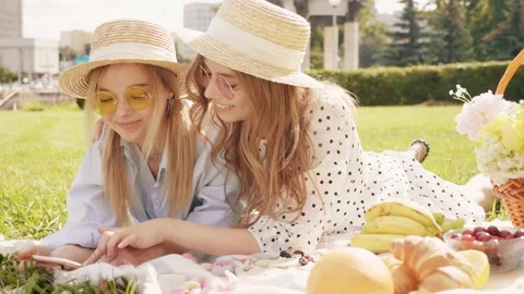 Two young beautiful smiling hipster girls in trendy summer sundress Stock Footage 142568344