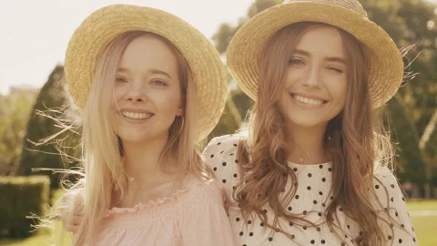 Two young beautiful smiling hipster woman in trendy summer sundress Stock Footage 142584535