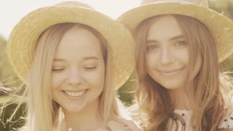 Two young beautiful smiling hipster woman in trendy summer sundress Stock Footage 142584831