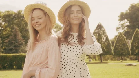 Two young beautiful smiling hipster woman in trendy summer sundress Stock Footage 142585084