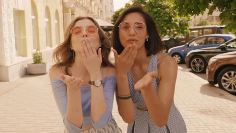 Two young beautiful smiling hipster girls in trendy summer clothes Stock Footage 146031796