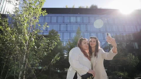 Two young beautiful smiling hipster women in trendy summer clothes, selfie Stock Footage 262141931