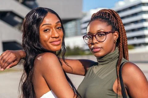 Two young black friends posing looking at camera Stock Photos