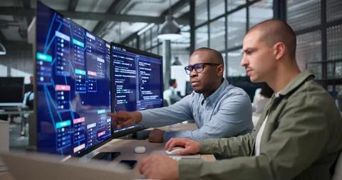 Two Young Black Men Collaborate On Visual Workflow Editor Using Software. Stockfoto's