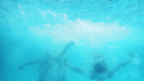 Two young boys dive into the pool Stock Footage 83144514