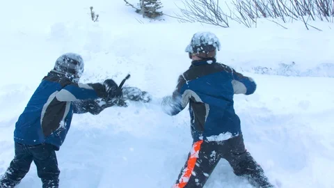 Two Young Boys Having a Snow Fight Stock Footage 102931751