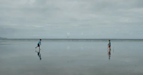 Two Young Boys Playing Beach Cricket, he's out! Vídeo Stock 79796817