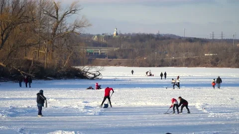 Two Young Boys Playing Pond Hockey During The Ontario COVID-19 Pandemic Stock Footage 148335832