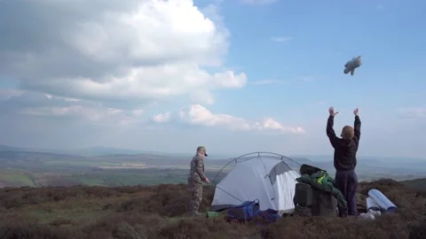Two young boys setting up a camping tent in the countryside Stock Footage 152529609