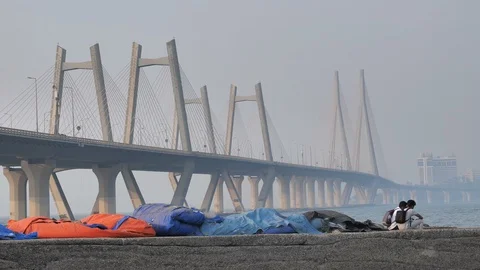 Two young boys sitting and talking against the modern cable stayed bridge 動画素材 86517223