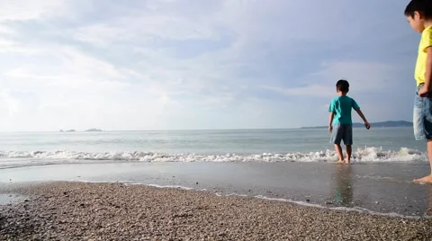 Two young boys standing on the beach Stock Footage 57831926