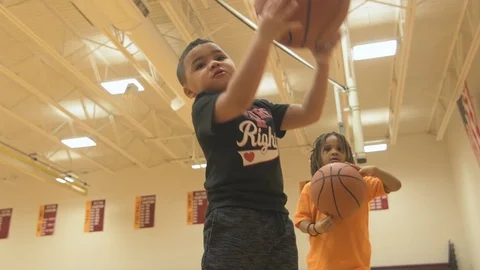 Two Young Boys Try To Spin Basketball On Finger Stock Footage 88370180