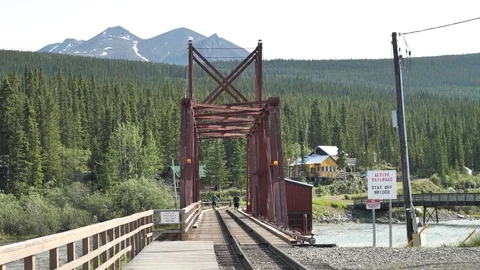 Two Young Boys Walk Across Carcross White Pass Railway Bridge Stock Footage 80737155