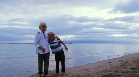 Two Young Brothers on Beach at Sunset. Stock Footage 52221708