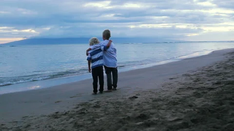 Two Young Brothers on Beach at Sunset. Stockbeeldmateriaal 52221722