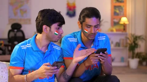 Two young brothers checking the live cricket score - placing online bets, Ind... Video stock 254399129