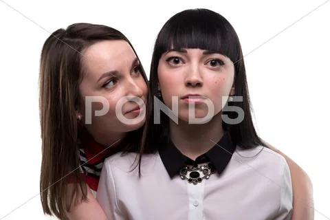 Two young brunette women - serious and smiling Stock Photos