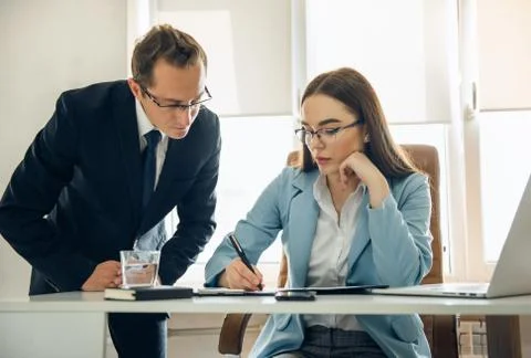 Two young business colleagues working on computer. Stock Photos