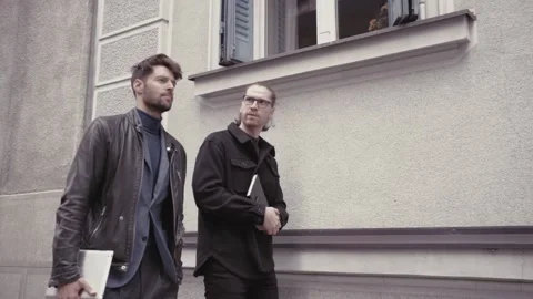 Two young business men walking on the street Stock Footage 152044902