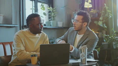 Two Young Businessmen Discussing Plan on Laptop in Coworking Office Stock Footage 274625080