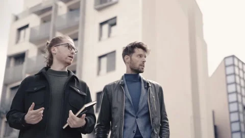 Two young businessmen going down stairs. Video stock 152520284