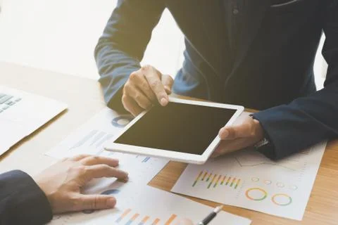 Two young businessmen using touchpad and analysis business chart document a.. Stock-Fotos