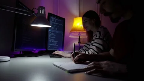Two young caucasian programmers are sitting in front of computer and developing Stock Footage 151720635