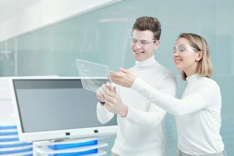 Two young cheerful software developers preparing presentation of new program Stock Photos