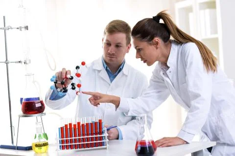 Two young chemist students researching at school lab Stock-Fotos
