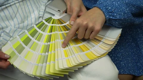 Two young clients choosing paint color from palette for wall paint Видео 266936719