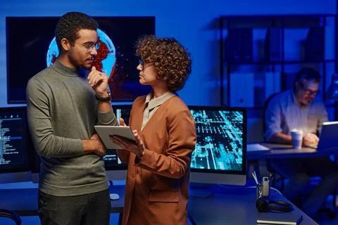 Two young confident programmers discussing ideas for new creative project Stock-Fotos