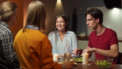 Two young couple talking joyfully at dinner Stock Footage 114813622