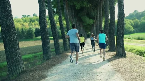 Two young couples in a park race, slow motion Video stock 14815309