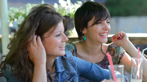 Two young couples sitting, talking, laughing and enjoying some food and drinks Stock Footage 55281021
