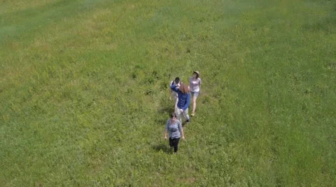 Two young couples walking on green field Stock Footage 56017587