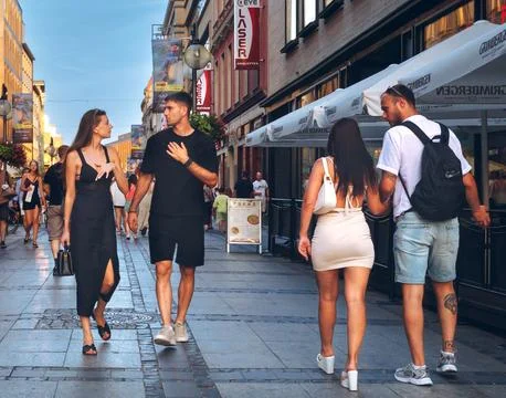Two young couples walking toward each other Фото