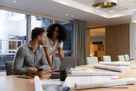 Two young creative professionals working together in a modern office Fotos Stock