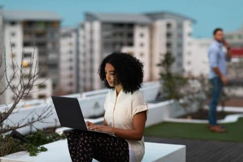 Two young creative professionals working on a office roof terrace Stock Photos