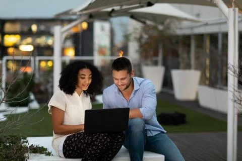 Two young creative professionals working on an office roof terrace 库存照片